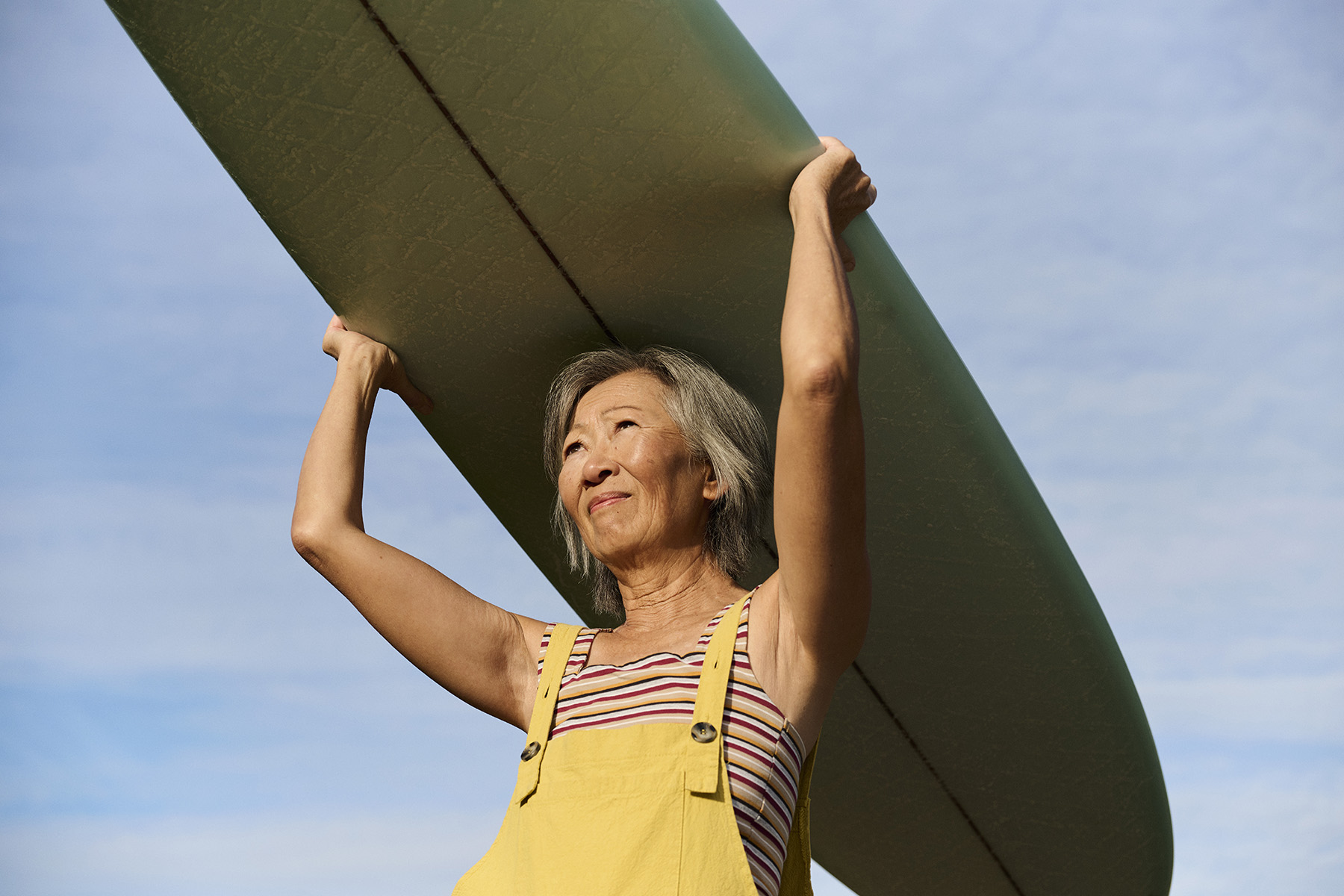 a woman holding a surfboard